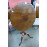 A George IV mahogany circular tilt top tripod tea table