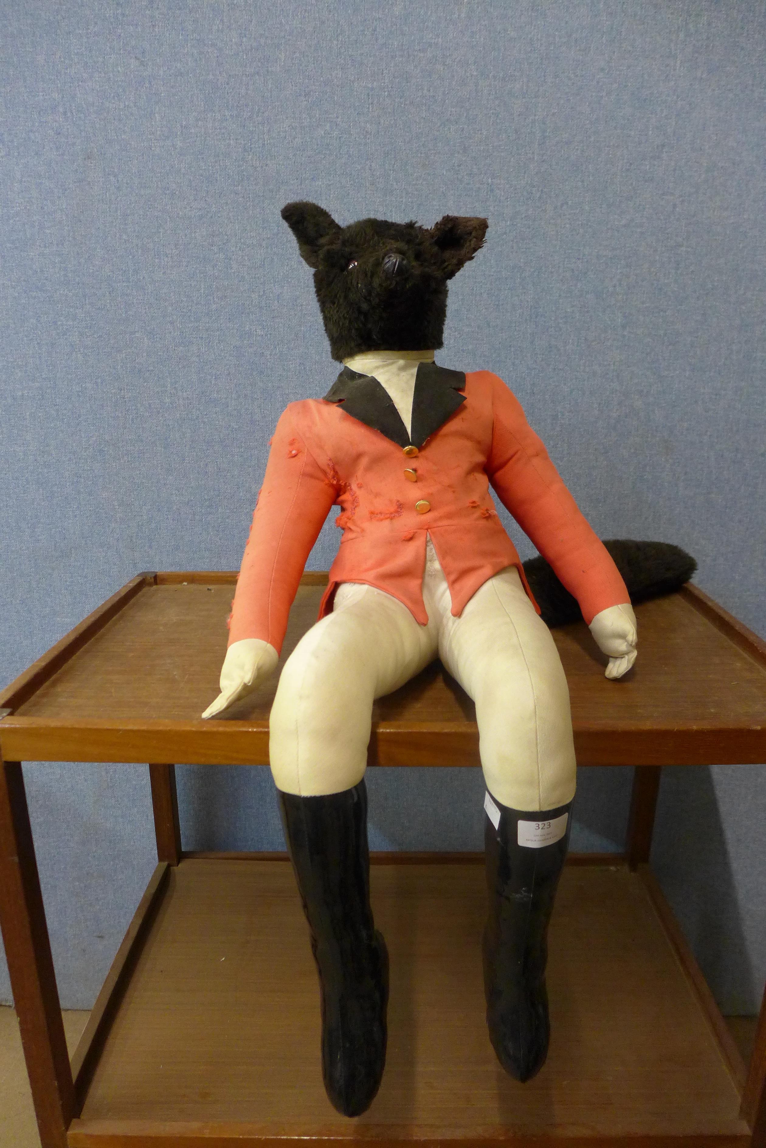 A vintage soft toy fox in hunting attire