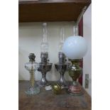 Four assorted oil lamps