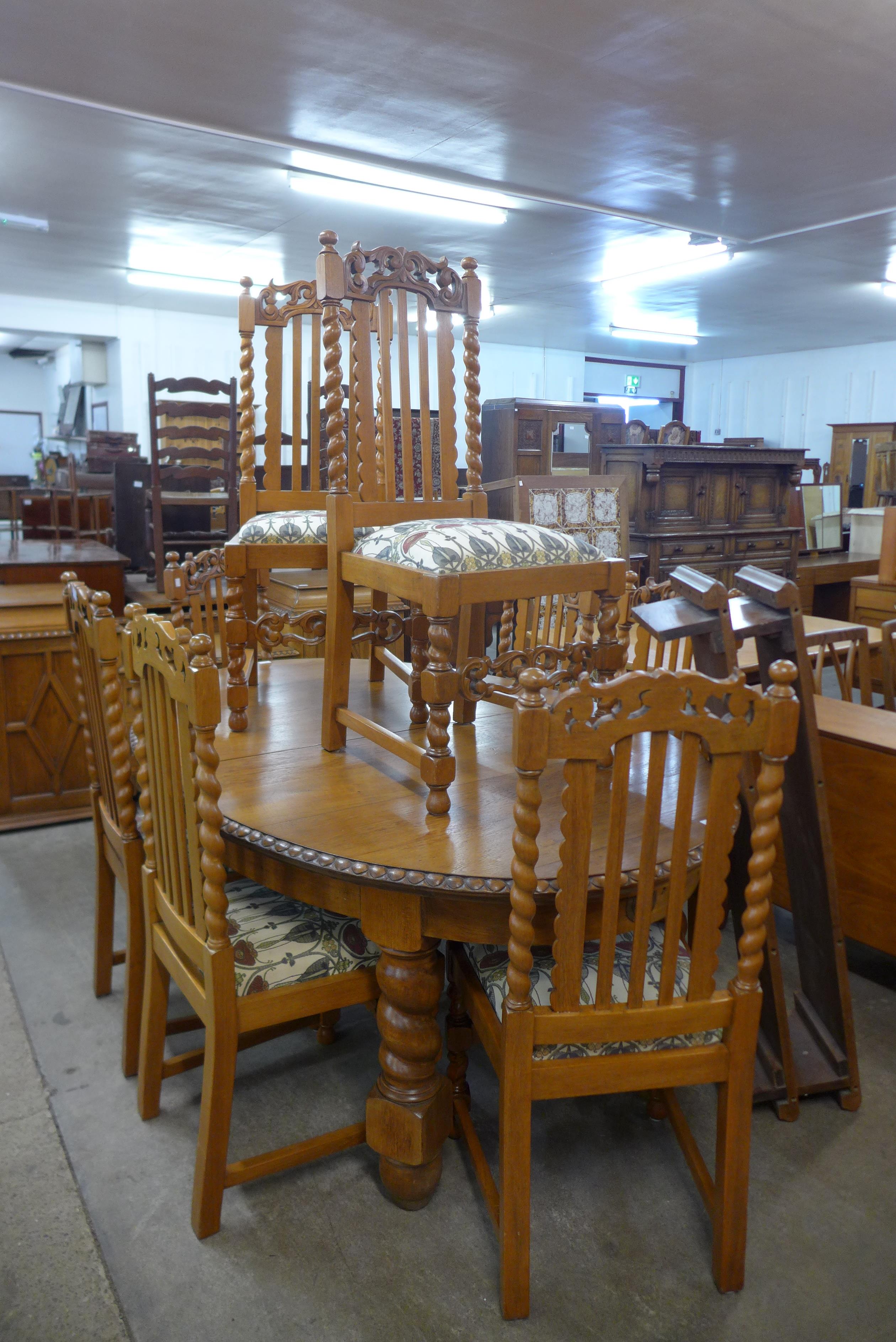 A carved oak barleytwist ten piece dining suite, comprising extending table, eight chairs and buffet