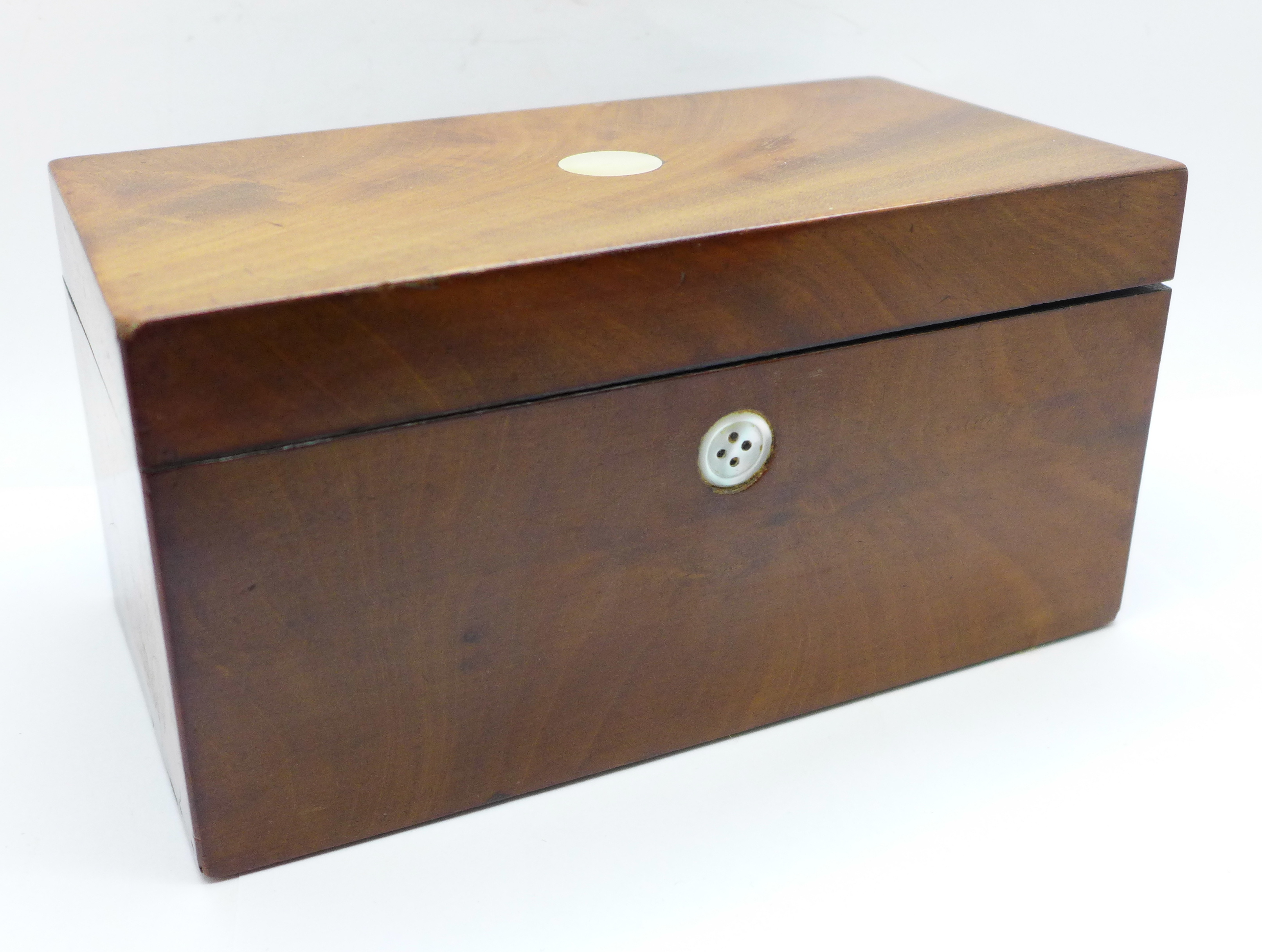 A Georgian walnut tea caddy with mother of pearl inlay (one inlay replaced with button)
