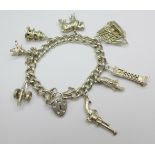 A silver charm bracelet with eight large charms, total weight 70g