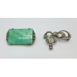 A silver brooch set with a carved jade panel depicting a lake scene with trees, also set with