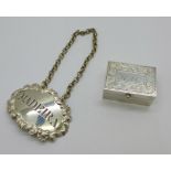 A George III silver decanter label, 'Madeira', John Reily, London 1818, 18g, and a silver pill