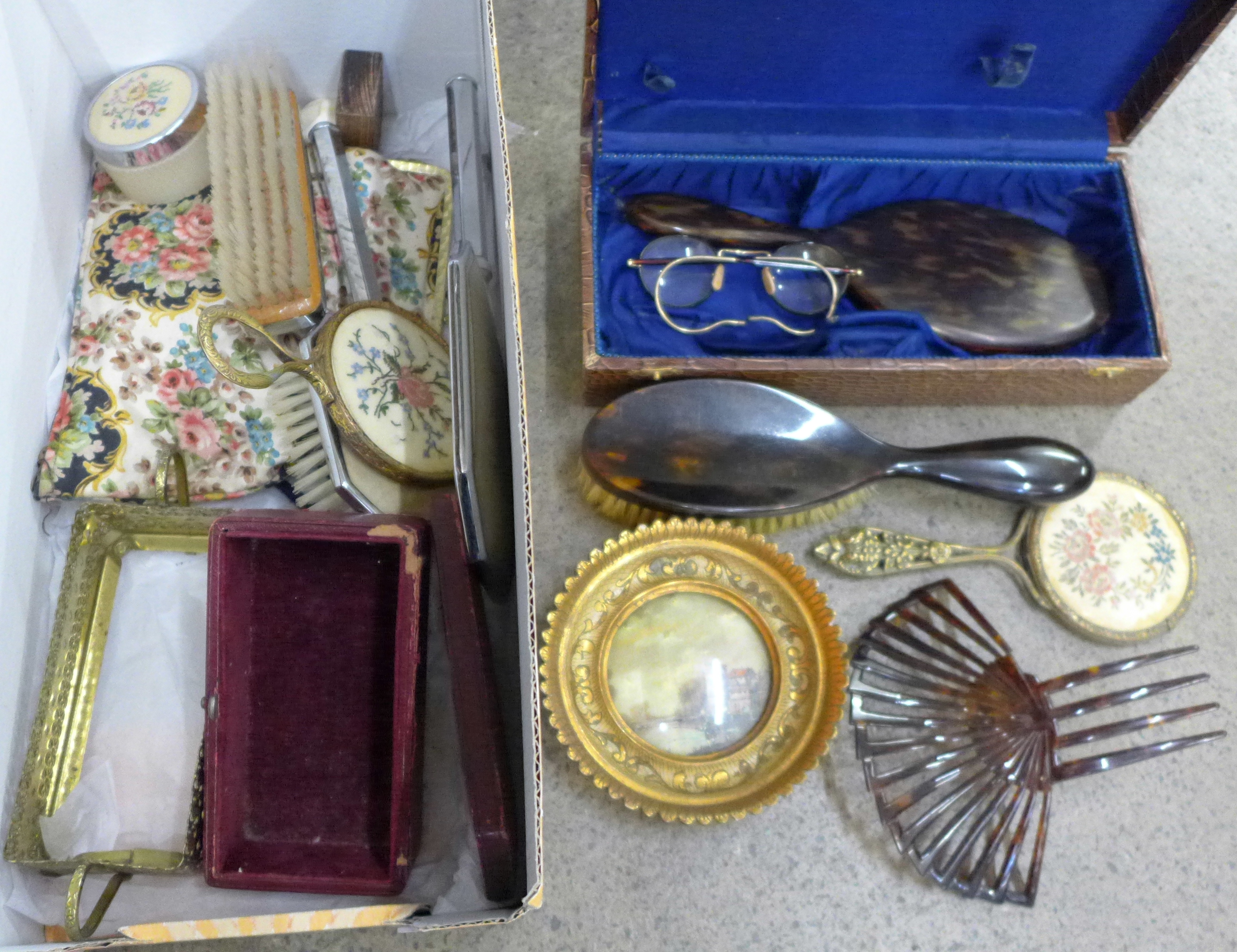 A pair of tortoiseshell rimmed spectacles, brush and mirror set, hair comb, etc.
