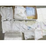 A box of linen including needlework, crochet, lace edged, Edwardian top and shorts, table cloth,