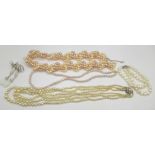 Three pearl necklaces, one with 9ct gold clasp and one with silver clasp set with white stones, a