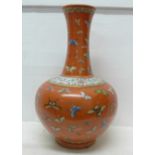 A Chinese coral red ground Famille Rose 'butterfly vase', bulbous body and tall, waisted neck,