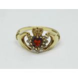 A 9ct gold, garnet set gold Claddagh ring, 1.9g, P