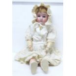 A Max Handwerck German doll, bisque head, composition body and limbs, brown eyes, open mouth with