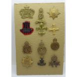 A collection of twelve military cap badges