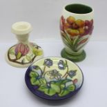Three pieces of Moorcroft; small vase, dwarf candlestick and small dish
