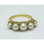 A yellow metal and pearl ring, tests as 18ct gold, 4.8g, M/N