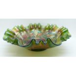 A green carnival glass dish with wavy edge and grape design, 21.5cm