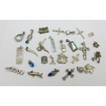 Fourteen pendants and thirteen charms including silver
