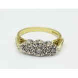 An 18ct gold and three stone diamond trilogy ring, 3.5g, L