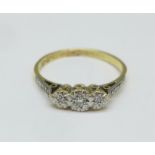 An 18ct gold and three stone diamond ring, 2.6g, P