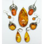 Four pairs of amber set earrings, the small pair marked 925, and a large amber pendant