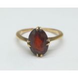 A yellow metal and garnet ring, 2.2g, L