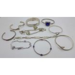 Five silver bracelets including a charm bracelet and five silver bangles including one snake bangle