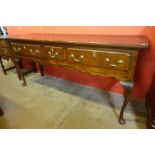 A George III oak dresser, with later associated rack