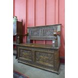 An Elizabethan Revival carved oak box settle