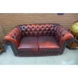 A red leather Chesterfield two seater settee