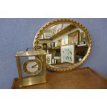 A gilt framed oval mirror and a Seiko mantel clock