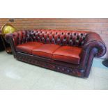 A red leather Chesterfield three seater settee