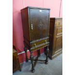 A 17th Century style carved oak cabinet on stand