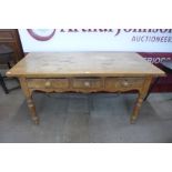 A Victorian pine three drawer farmhouse kitchen table