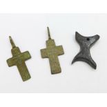 Two bronze Viking crosses and a bone amulet, found in Russia