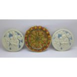 A Della Robia circular plate a/f and two blue and white relief moulded circular plaques, plate 14.