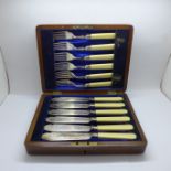 A cased set of fish knives and forks with silver ferrules in a fitted wooden box