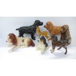 A black Beswick Spaniel, a brown Royal Doulton Spaniel, three other models of dogs, one a/f, a