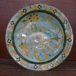 A c1900 Della Robbia shallow bowl decorated with a stylised swan, cracked and with firing crack on
