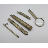 A novelty hallmarked silver pencil holder magnifying glass, a silver cheroot holder case, a silver
