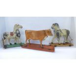 A pull-along toy cow and two 19th Century pull-along toy horses, height of horses 25cm