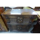 A 17th Century style carved oak credence cupboard