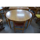 A teak extending dining table and four chairs