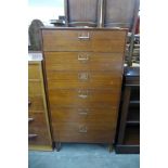 A teak chest of drawers