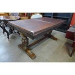 A 17th Century style carved oak draw leaf refectory table