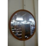 A teak framed circular mirror