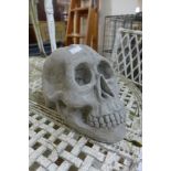 A concrete primate skull garden ornament
