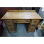 An Edward VII oak kneehole desk