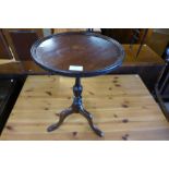 An inlaid mahogany tripod wine table