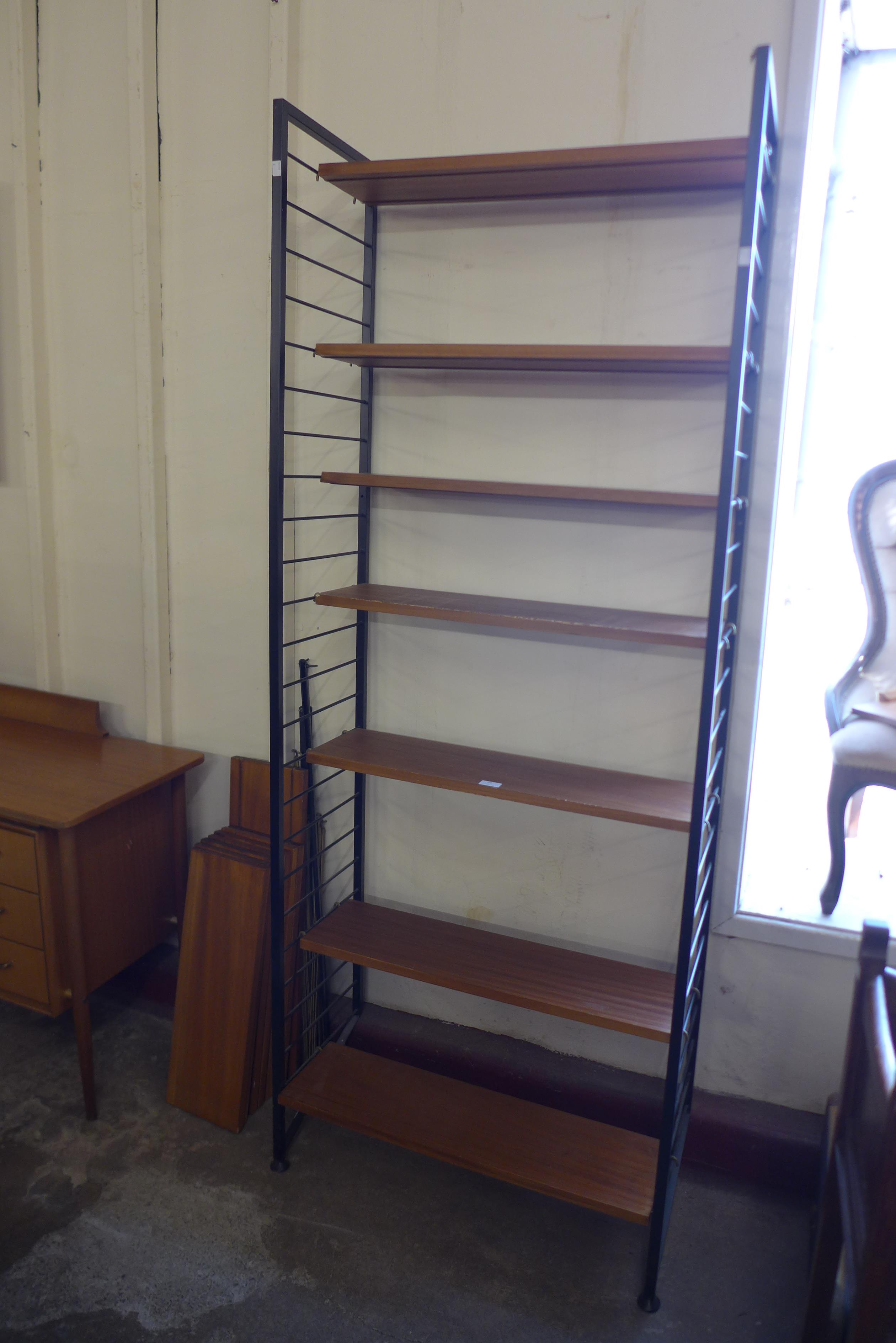 A teak and black metal Ladderax room divider with extra shelving
