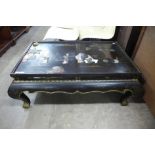 An oriental chinoiserie ebonised coffee table (lacking glass )