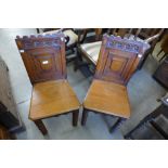 A pair of Victorian Gothic Revival oak hall chairs