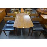 A teak drop leaf table and four chairs